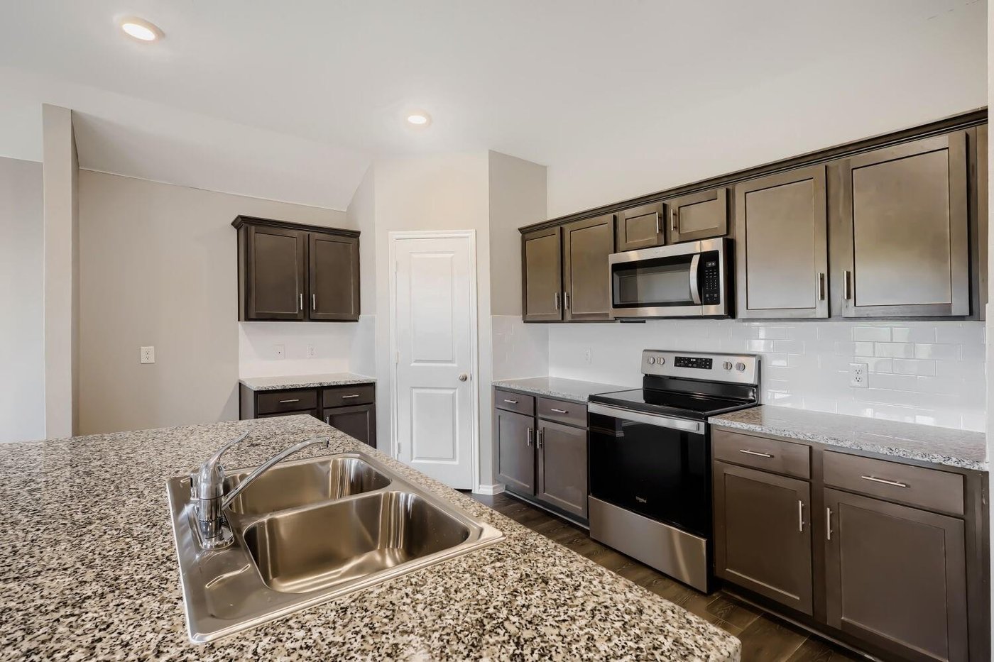 Kitchen with a granite island and stainless steel appliances at 1212 Rountree Ct, Celina