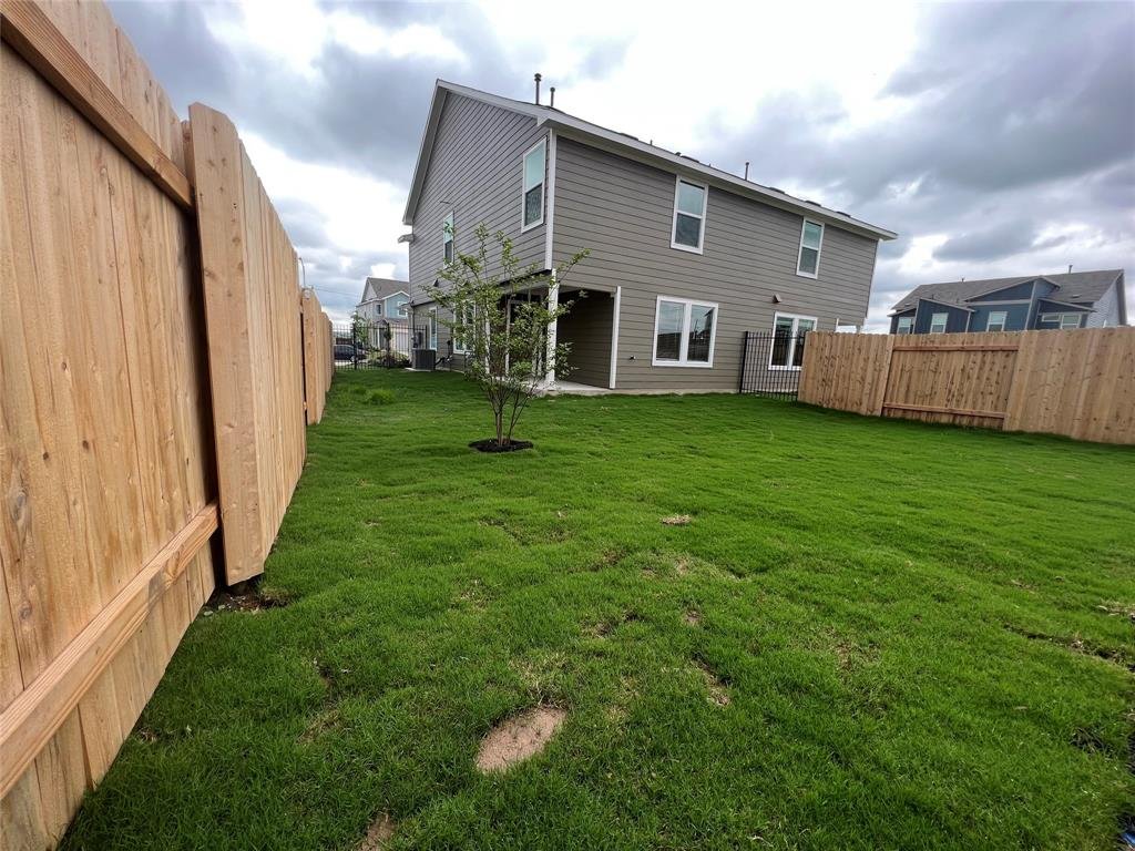 Private backyard with a covered porch at 7224 Spotted Leaf Way, Del Valle TX