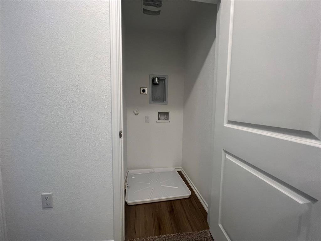 Upstairs laundry room with washer and dryer at 7224 Spotted Leaf Way in Del Valle